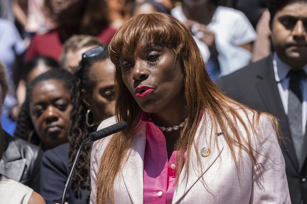Ingrid Lewis-Martin stands in front of a crowd of people.