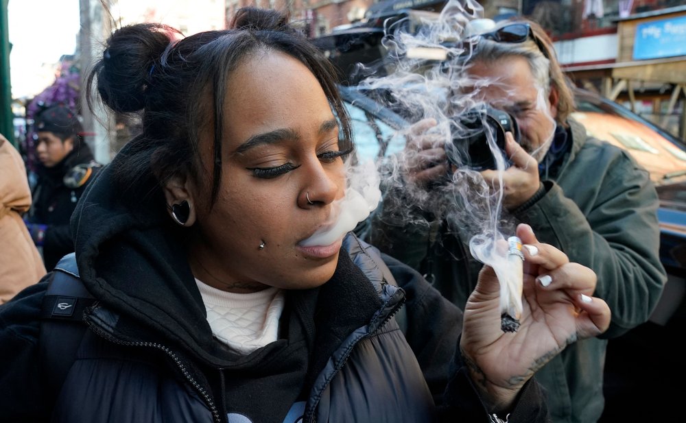 A customer smokes marijuana during the grand opening of Smacked in the Greenwich Village neighborhood of New York City on Jan. 24, 2023.