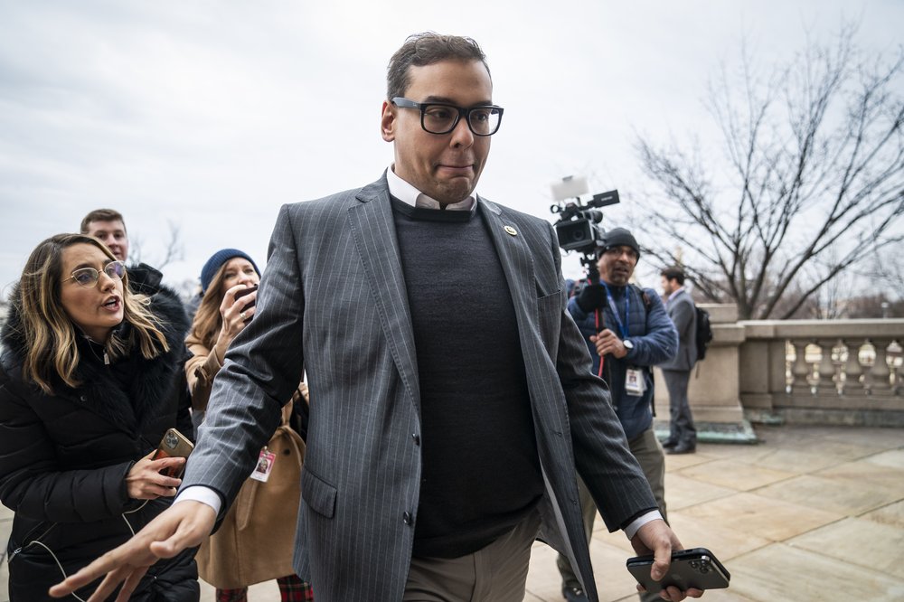 George Santos is chased by reporters.