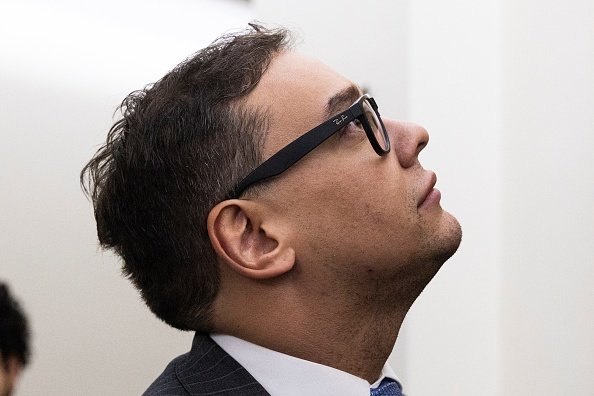 A close up of George Santos looking to the side