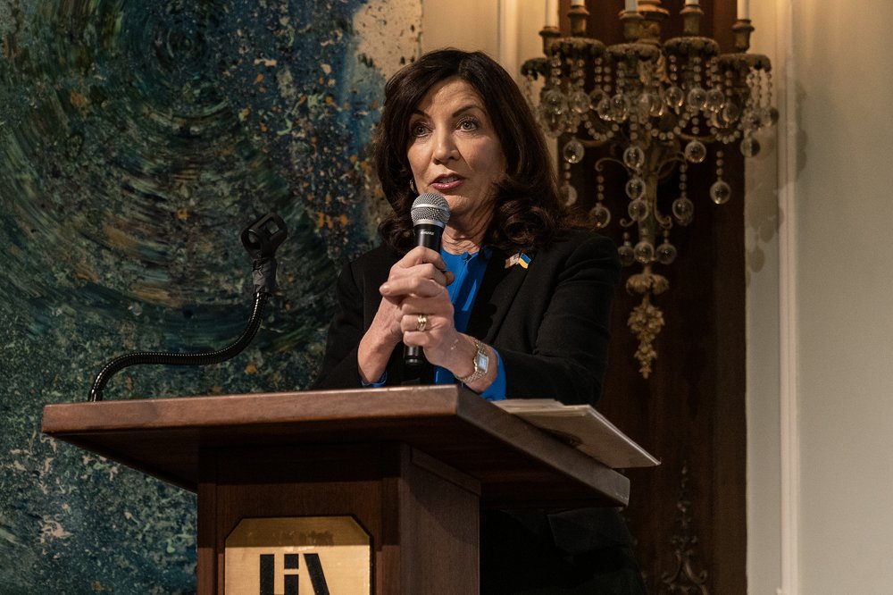 Gov. Kathy Hochul speaks into a microphone behind a podium.
