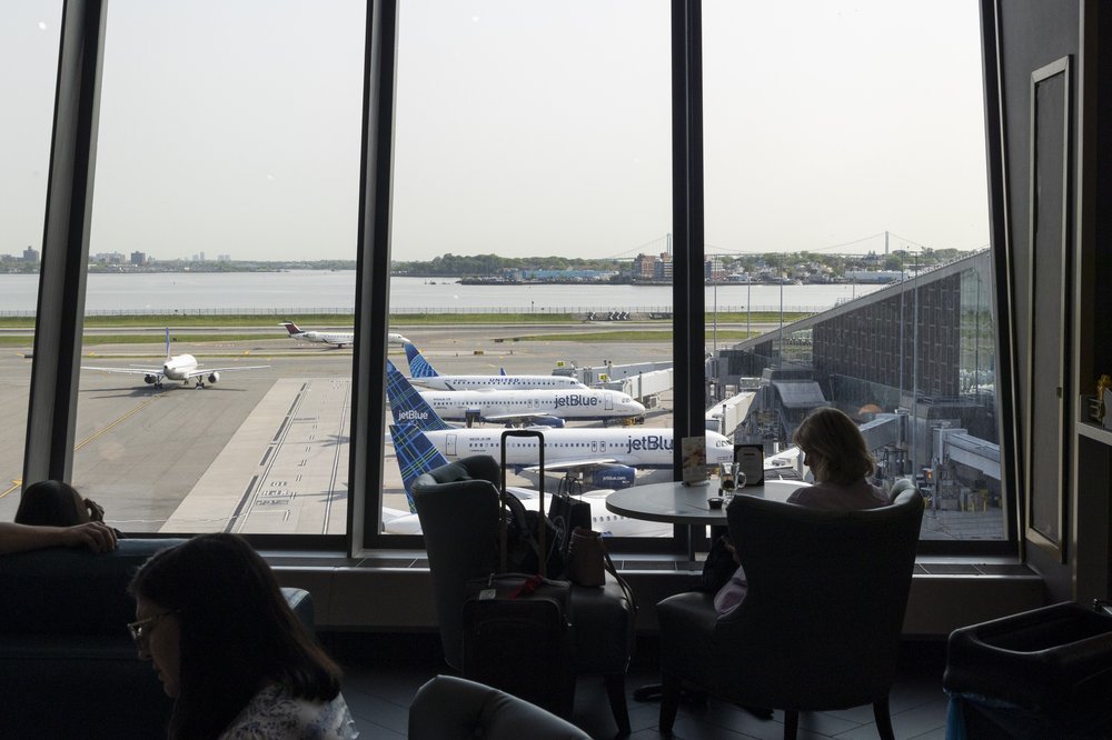 A passenger sits in a terminal at LaGuardia Airport in Queens on May 11, 2023.