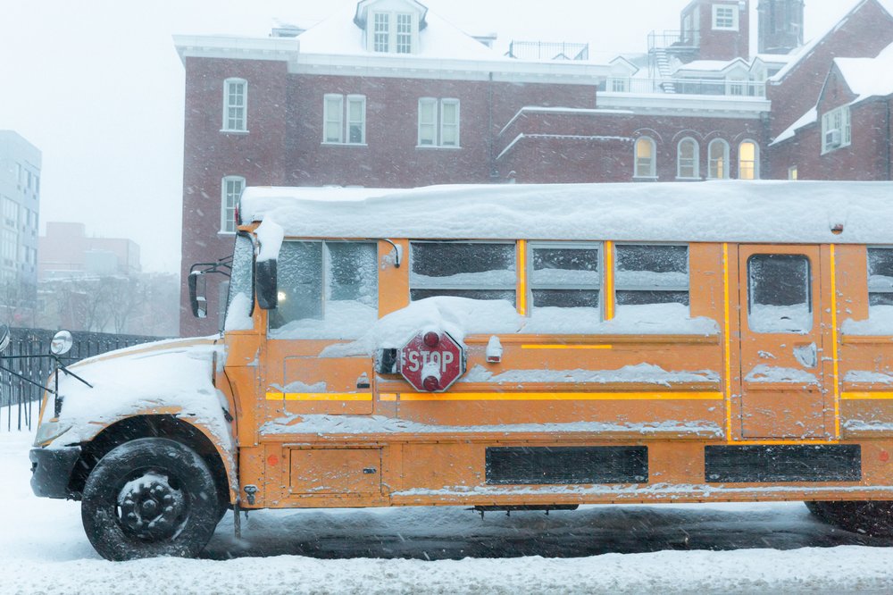 A school bus covered in snow.