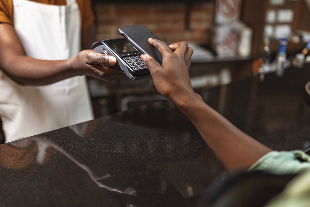 A cashier takes a payment from a customer.
