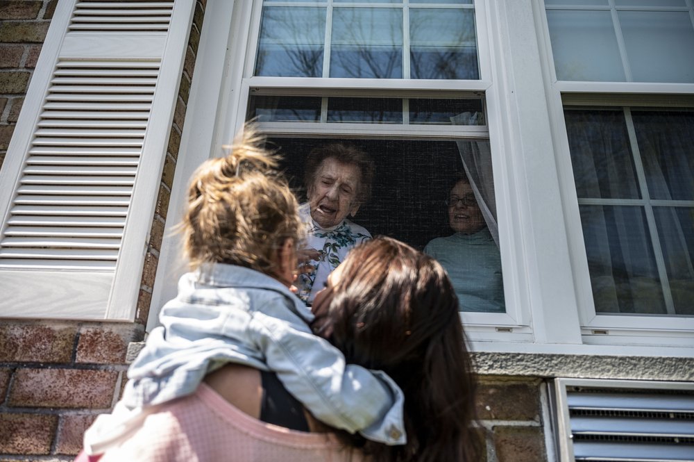 Sister Francis Piscatella of the Sisters of St. Dominic of Amityville says hello through a window to family members wishing her a happy 108th birthday on April 20, 2021.