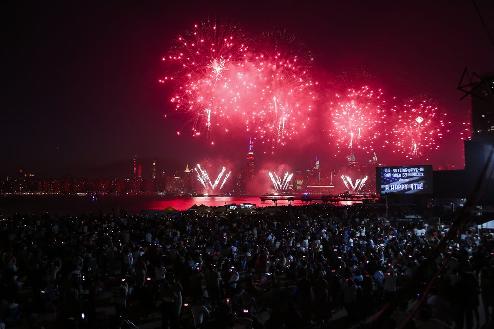 Spectators watch Macy's Fourth of July fireworks show in Brooklyn on July 4, 2021.