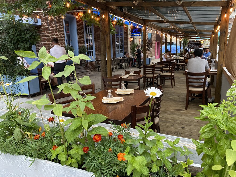 Outdoor dining at REEF restaurant in Queens.