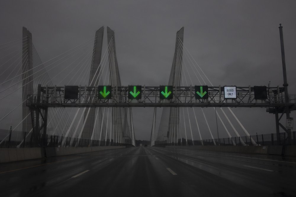 A bridge pictured against a gray sky.