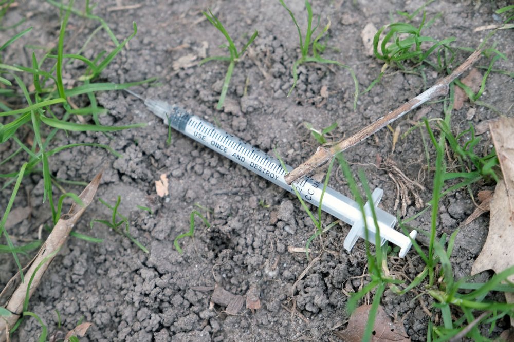A used syringe lies on the ground in a park in New York City on Oct. 08, 2021.