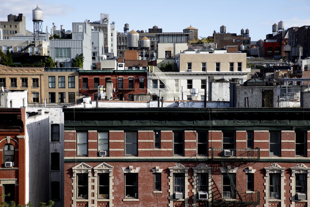 High up views of Soho in Manhattan, a series of brick buildings with red, tan and white hues.