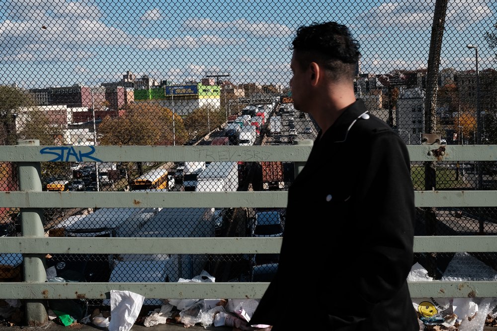 A man on a bridge looks at gridlock on the Cross Bronx Expressway.