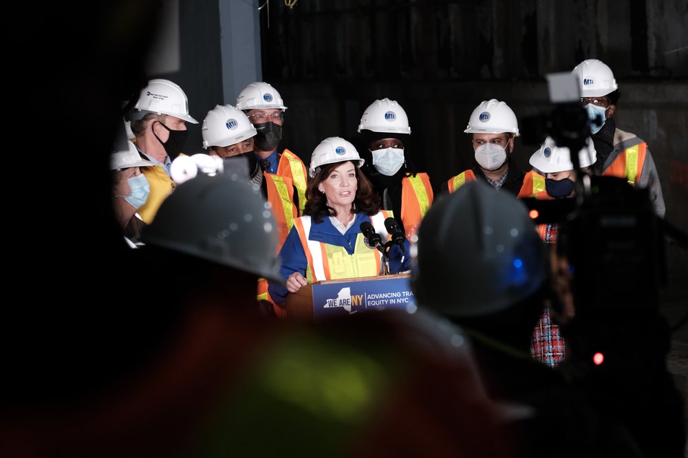 Gov. Kathy Hochul tours a tunnel being constructed for the Second Avenue subway, flanked with other officials all wearing hardhats.