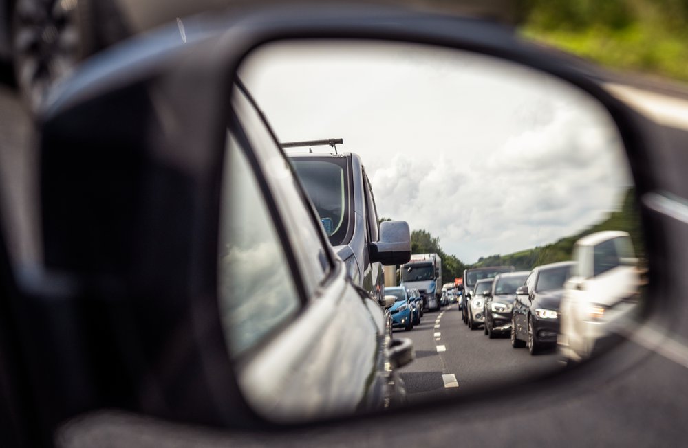 A traffic jam seen in a car's side mirror.
