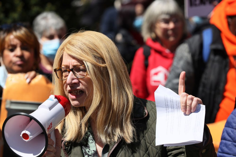 Assembly member Linda Rosenthal holds a megaphone up to her mouth during a housing protest in City Hall Park.