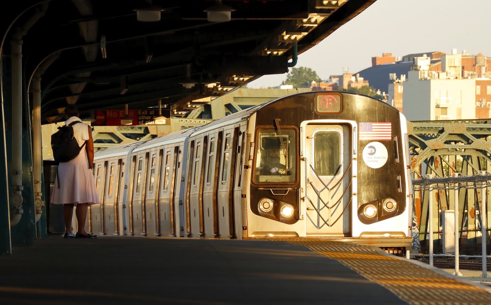An F train pulls into a Brooklyn subway station.