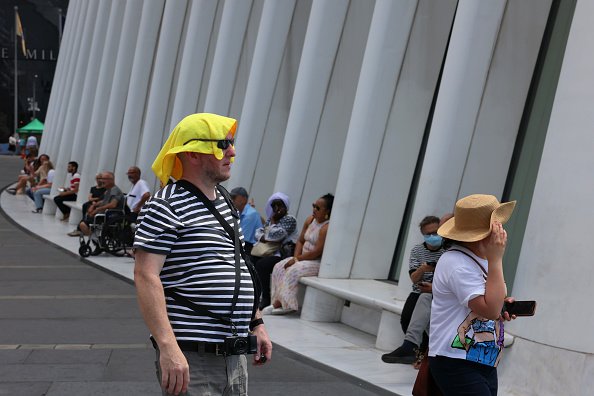A man walks outside in the heat.