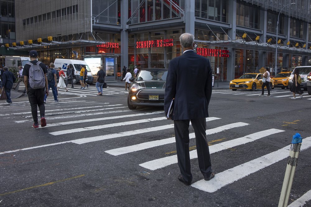 A man waits to cross 8th Avenue on August 29, 2022 in Times Square.