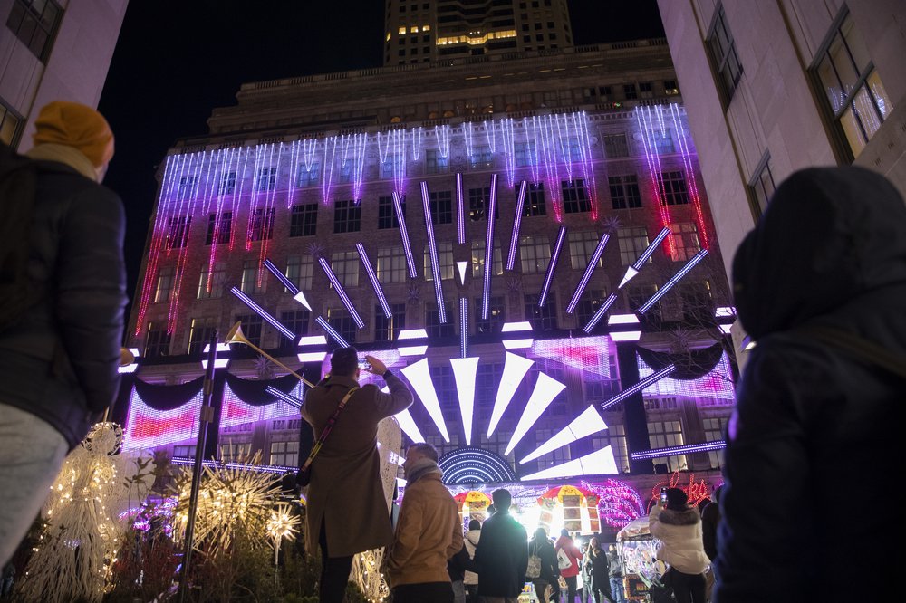 Tourists enjoy the holiday light show at Saks Fifth Avenue in Manhattan on Nov. 28, 2022.