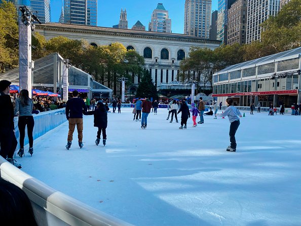 People skate in a rink in New York City.