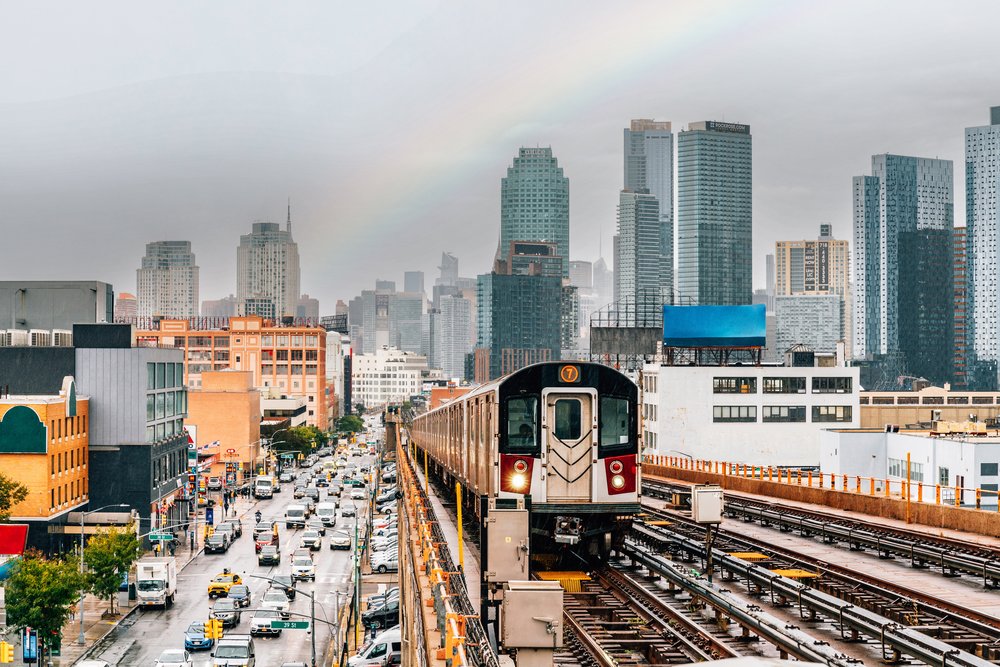 New York City subway train is approaching an elevated subway station in Queens.