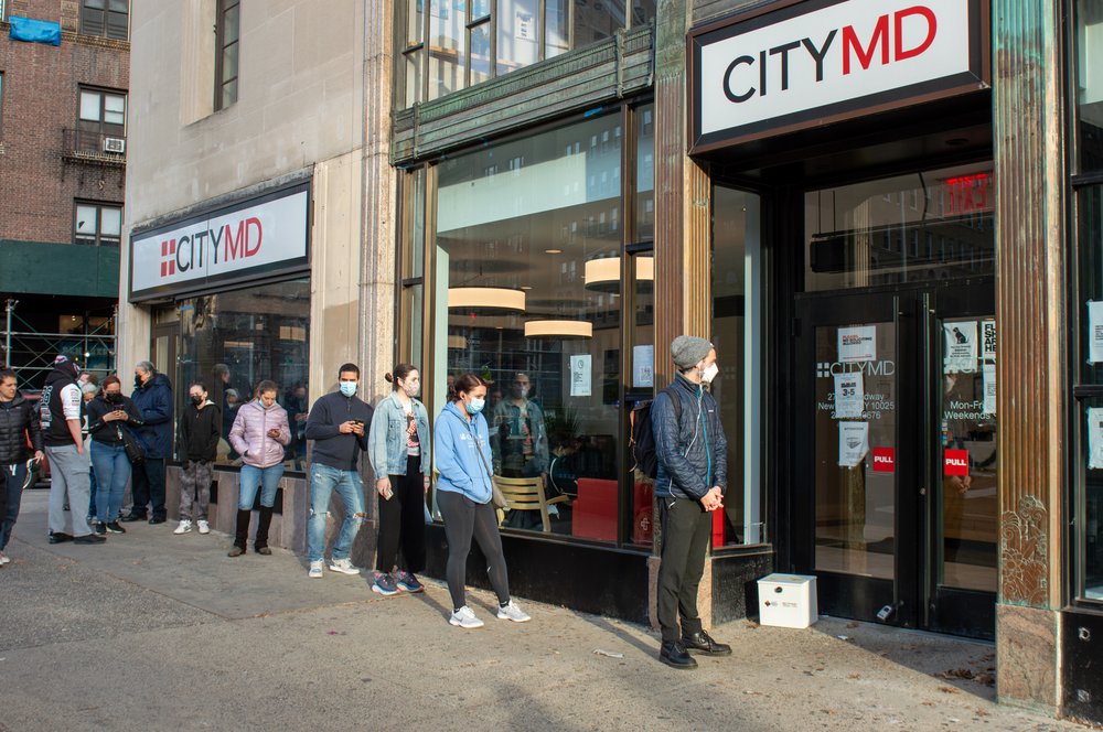 : A line of people waiting to get a COVID test at CityMD in December 2021.