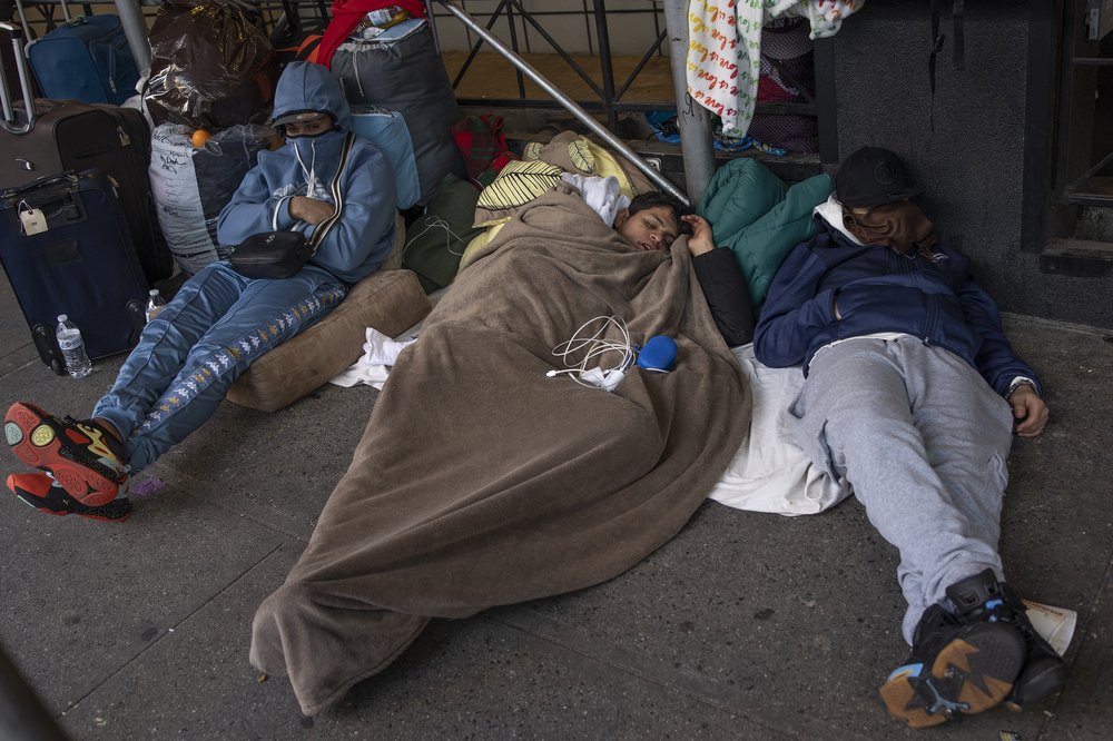 Venezuelan migrants bused to New York City from the Texas border outside the Watson Hotel in Midtown on Jan. 30, 2023.