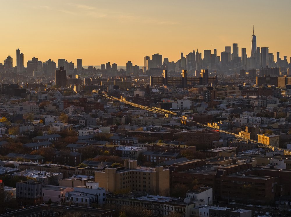 Downtown Manhattan is seen in the distance from over Bushwick, Brooklyn
