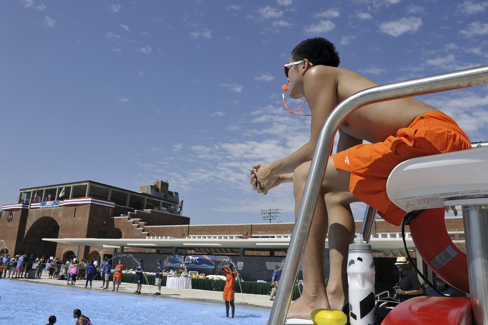A lifeguard watches over swimmers at McCarren Pool in Brooklyn.