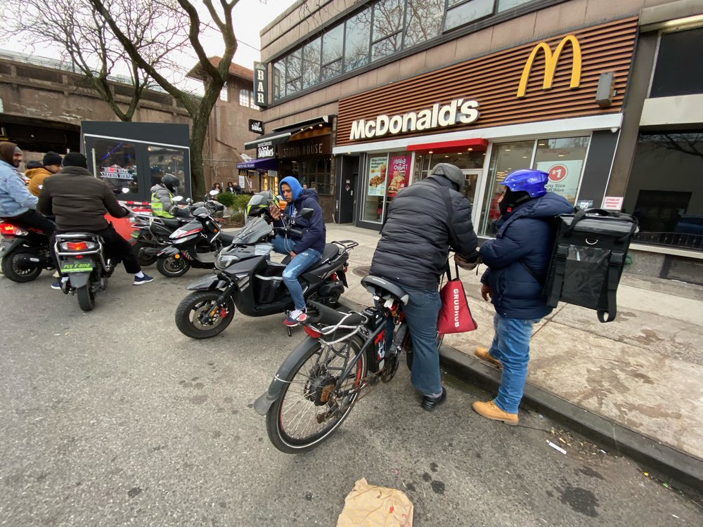 Delivery workers outside a McDonald's.