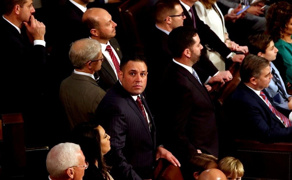 Congressman Anthony D'Esposito on the floor of the House chamber surrounded by his colleagues.