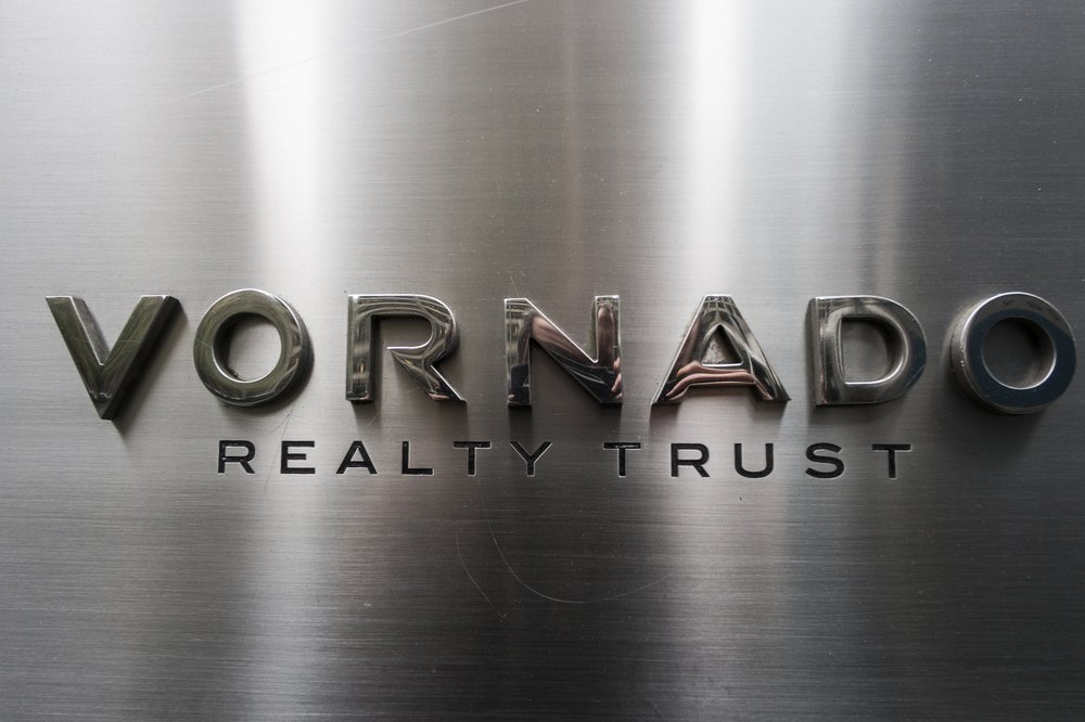 A logo on a metallic wall.