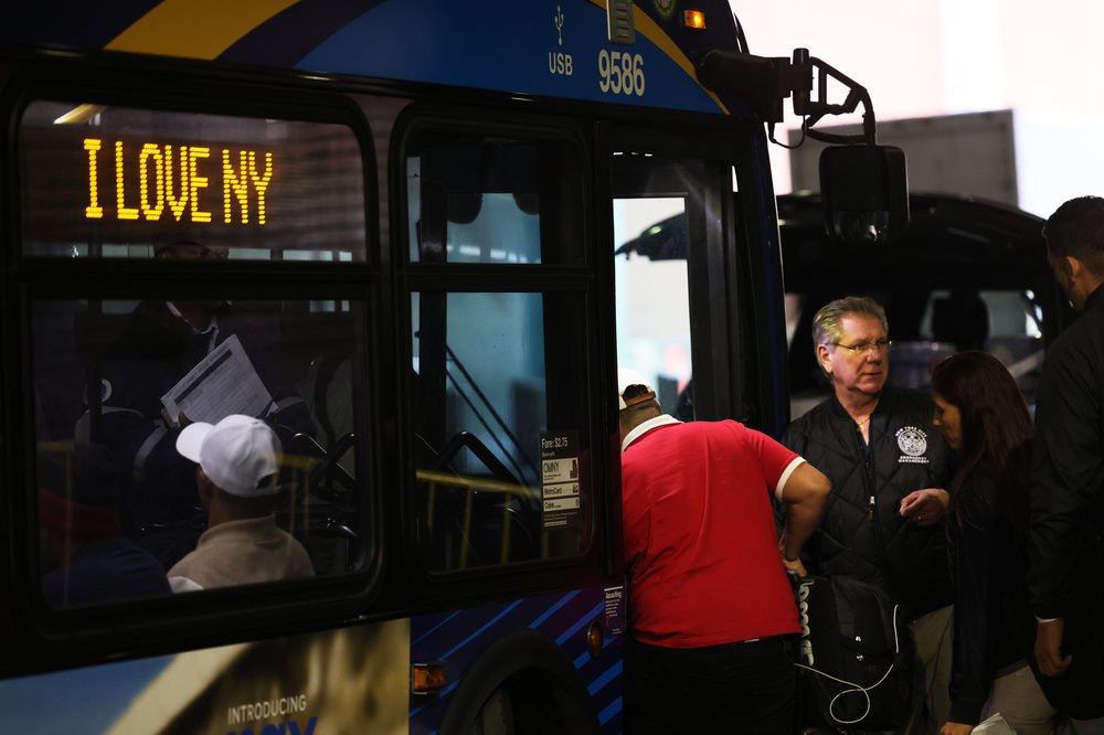 Asylum seekers board a bus en route to a shelter at Port Authority Bus Terminal in May 2023.
