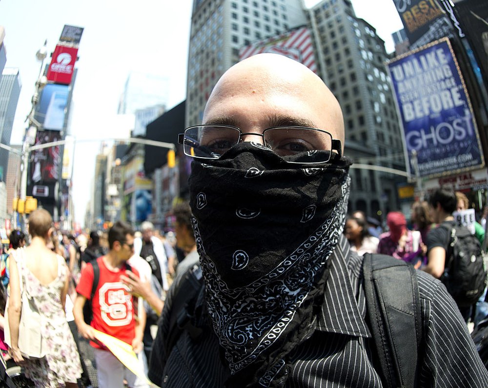 A man wears a black bandana over his face during a protest in 2012.