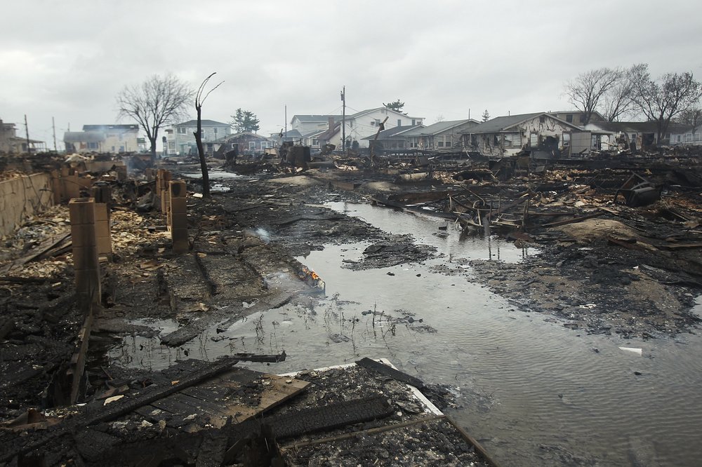 Homes destroyed during Hurricane Sandy are viewed on October 30, 2012 in the Breezy Point neighborhood of the Queens borough of New York. At least 33 people were reported killed in the United States by Sandy as millions of people in the eastern United States have awoken to widespread power outages, flooded homes and downed trees. New York City was hit especially hard with wide spread power outages and significant flooding in parts of the city. (Photo by Spencer Platt/Getty Images)