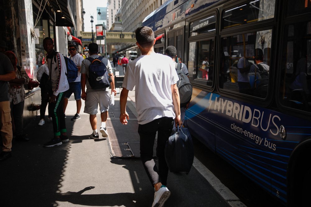 Migrants arrive on a bus outside the Roosevelt Hotel in midtown Manhattan.