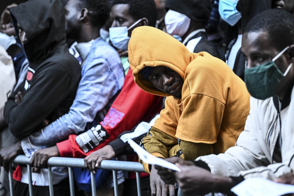 Migrants congregate outside Roosevelt Hotel in Manhattan on Aug. 2, 2023, waiting for placement inside a shelter. While the city has accommodated tens of thousands of migrants since an influx that began two years ago, it also provides for some 2,000 migrants who were sent to communities outside of New York City, including in Buffalo.