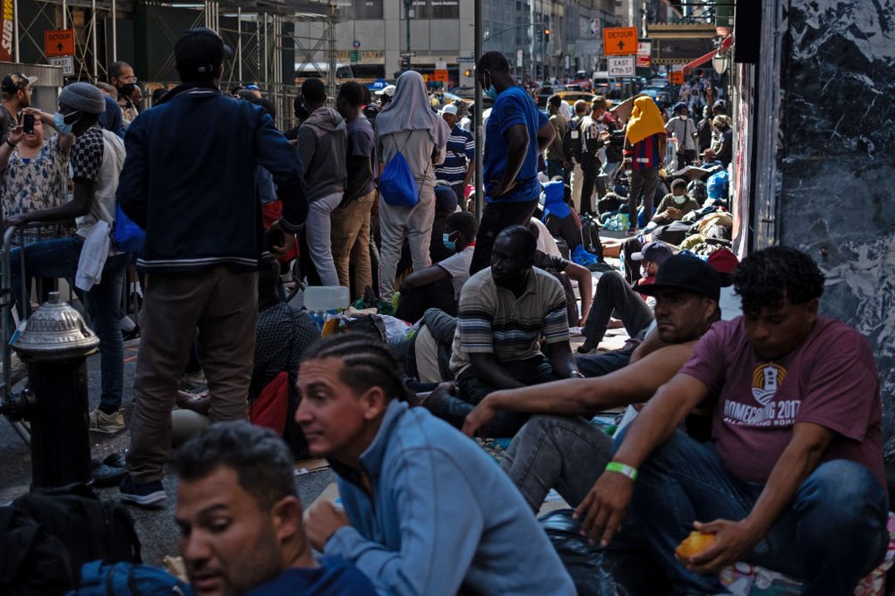 Migrants gather outside of the Roosevelt Hotel in Manhattan awaiting processing on Aug. 2, 2023.