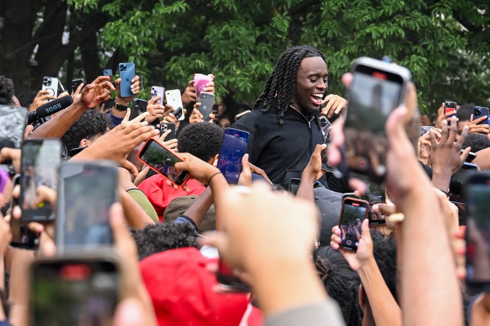 People gather around and cheer for Kai Cenat as members of the NYPD respond to thousands of people gathered for a "giveaway" event announced by popular the Twitch live streamer in Union Square and the surrounding area on Aug. 4, 2023.