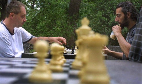 Two people play chess.