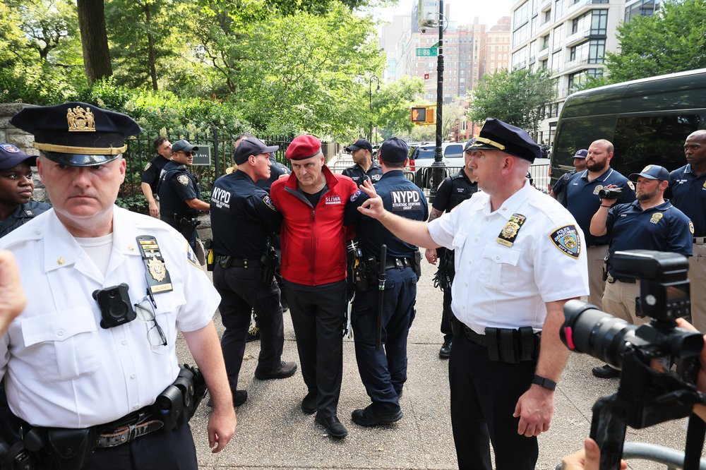 Guardian Angels founder Curtis Sliwa and supporters prepare to be arrested for civil disobedience during an anti-migrant rally and protest outside of Gracie Mansion on Aug. 27, 2023.