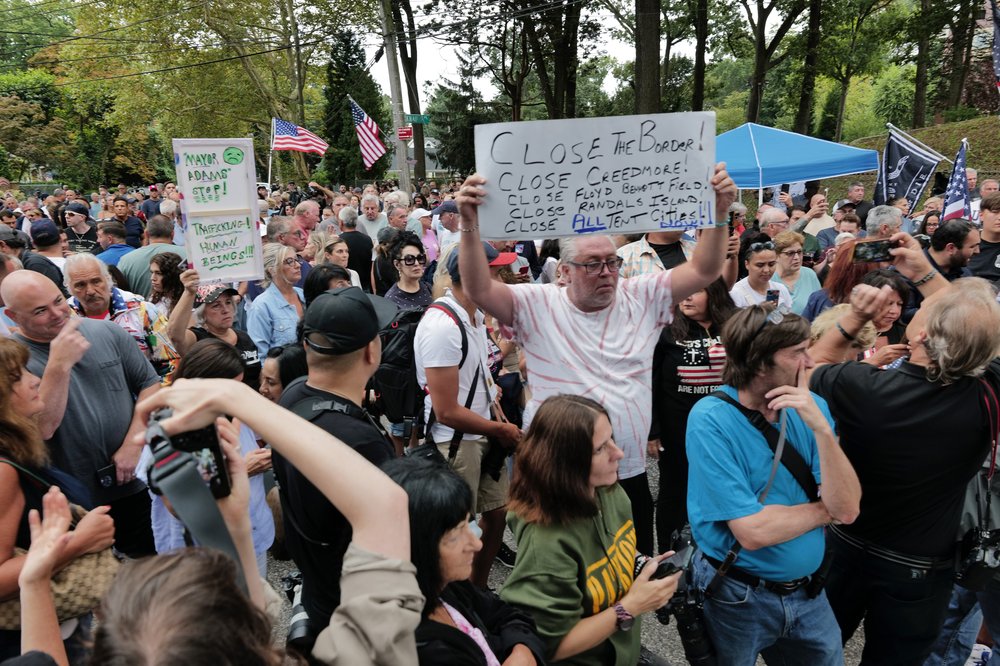 Staten Island residents gather to protest outside of a closed Catholic school-turned-migrant shelter.