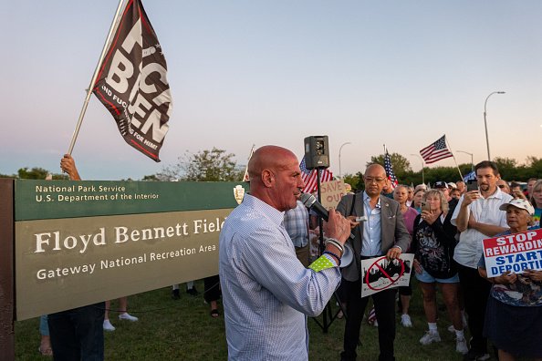 A man speaks at a rally against the housing of migrants at Floyd Bennett Field in Brooklyn