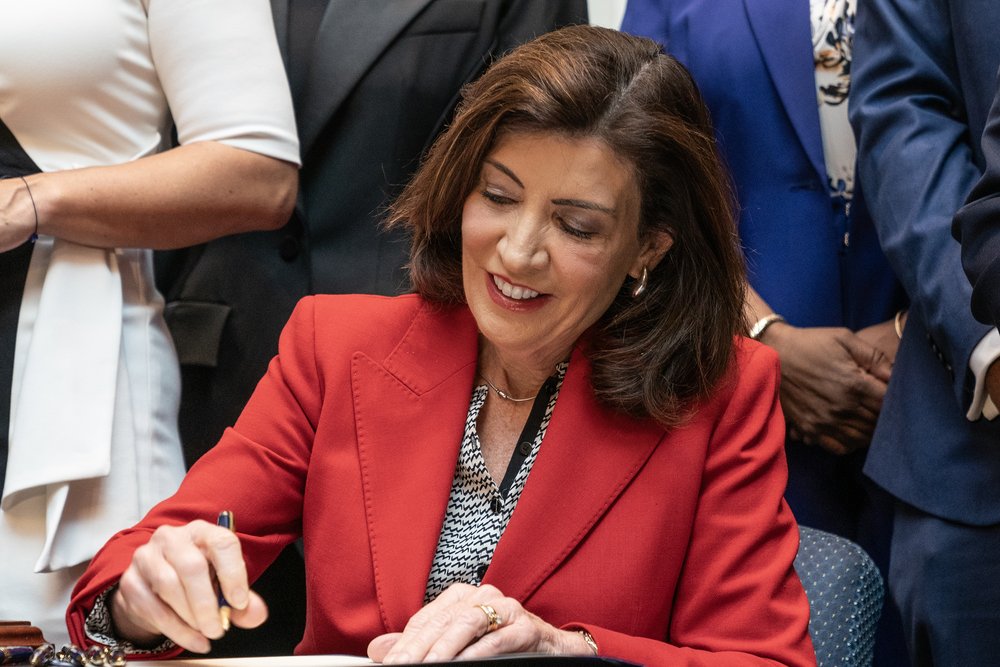 New York Gov. Kathy Hochul signs the Clean Slate Act into the law at the Brooklyn Museum on Nov. 16, 2023.