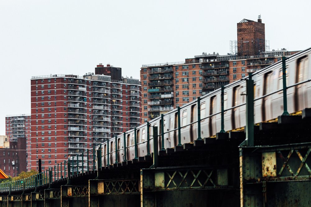 A subway train passes on elevated tracks in Brooklyn.