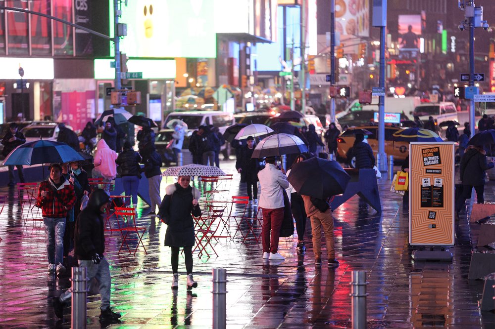 People walk around Times Square during the storm on Jan. 9, 2024.