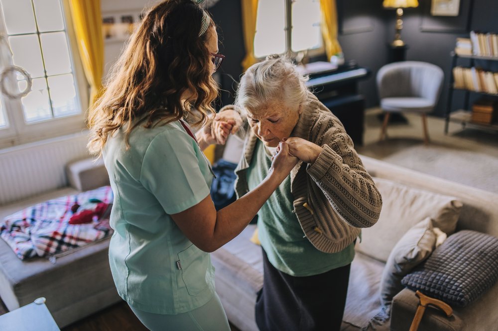 Image of a person being assisted by a home health aide