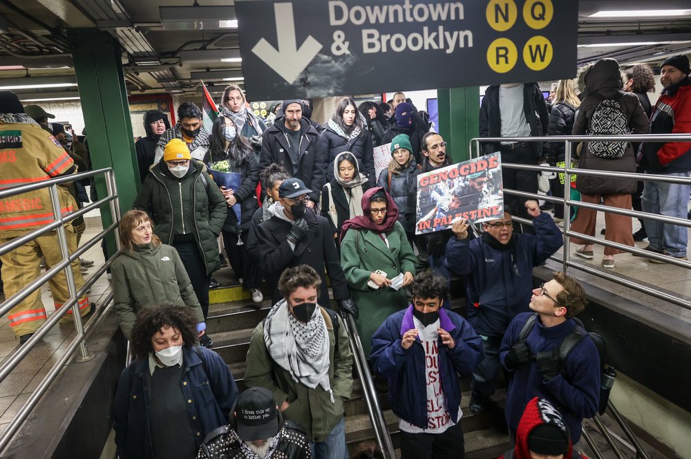 Protesters on the New York City subway, some wearing masks.