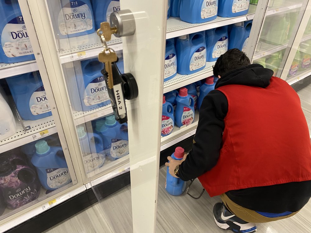 A store employee unlocks a cabinet with laundry detergent and fabric softener at a Queens Target store. Officials say they want to crackdown on shoplifting as increased complaints from retailers roll in.