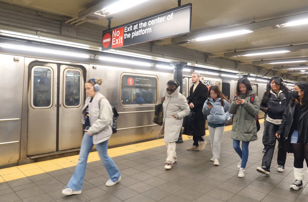 Subway riders on a platform.