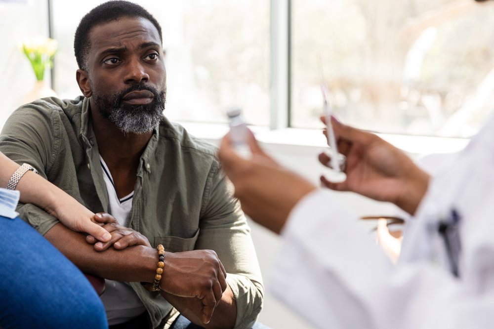 Picture of a man meeting with his doctors